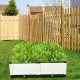 Elevated white planter box set with lush greenery, perfect for growing vegetables and herbs in your garden or patio.
