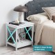White 2-tier side table with X-shape design, stable legs, and open shelf, perfect for living room or bedroom use.