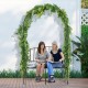 Steel garden arch with a 2-seat bench, featuring trellises for climbing plants, perfect for outdoor relaxation.