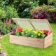 Wooden garden portable greenhouse with transparent PVC lid, featuring vibrant flowers for outdoor planting and growth.