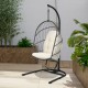 Hanging wicker egg chair with beige cushions, featuring a sturdy steel frame and designed for outdoor or indoor use.