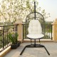 Hanging wicker egg chair with beige cushions and sturdy steel frame, perfect for outdoor patio relaxation.