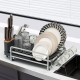 Aluminum expandable dish drying rack with drainboard, holding plates, glasses, and cutlery for organized kitchen.