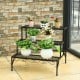 Ladder-style metal plant stand showcasing three tiers, perfect for displaying potted plants indoors or outdoors.