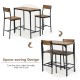 Bar table set featuring a black frame with wood grain tabletop and two stools, designed for space-saving convenience.