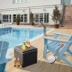 10-gallon black storage cooler with wood texture, used as a side table by the pool for outdoor activities.