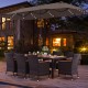 Patio dining set featuring a large acacia wood table, 8 stackable chairs, and a 15 ft double-sided umbrella for outdoor.