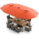 11-piece patio dining set featuring a 15-foot orange umbrella, acacia wood table, and comfortable rattan chairs for.