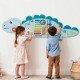 Dinosaur activity wall busy board for toddlers featuring xylophone, clock, and abacus for educational play.