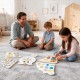Children engaging with the 11-in-1 Toddler Learning Activity Center on a carpet, featuring various educational.