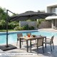 Gray 11 x 9 FT cantilever patio umbrella positioned by the pool, showcasing its 360° rotation and stylish double-tier.