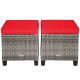 Set of two patio rattan wicker ottomans with removable red cushions, perfect for outdoor use in garden or poolside.
