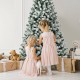 Snow-flocked 7-foot Christmas tree with 1116 tips and warm white lights, perfect for festive family gatherings.