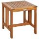 Acacia wood patio table featuring a slatted top, perfect for outdoor use in gardens or backyards.