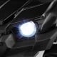 Bright LED headlight of a black 12V battery-powered electric vehicle for kids, enhancing safety and style.