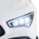 Close-up of the white Mercedes-Benz AMG CLA 45 kids ride-on car's LED headlights, featuring bright illumination for fun.