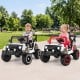 Two kids enjoy riding in the 12V Kids Ride on Truck with remote control, featuring bright lights and a smooth suspension.
