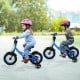 Kids riding 12-inch navy bikes with removable training wheels, adjustable seats, and dual brake methods for ages 3-8.