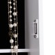 Close-up of the wall-mounted jewelry armoire with pearl necklaces, featuring a sleek design and organized storage.