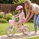 Pink 12-inch kids bike with adjustable seat, basket, and streamers, perfect for girls aged 3-4 years old.