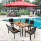 Acacia wood patio dining table with slatted surface and umbrella hole, perfect for outdoor gatherings by the pool.