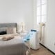 Portable 12000 BTU air conditioner in white, featuring smart control and 70° oscillation for effective cooling in.