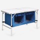 Height adjustable folding camping table in blue with large storage area, designed for easy transport and stability.