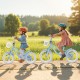 Two girls riding a 12-inch kids bike with adjustable handlebars and removable storage basket for outdoor fun.