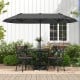 Double-sided gray patio umbrella with crank handle, providing ample shade for outdoor dining on the deck or patio.