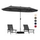 Double-sided gray patio umbrella with crank handle and two lounge chairs, ideal for poolside or garden shade.