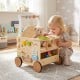 Wooden baby walker with wheels features engaging activities, storage, and a cozy seat for dolls, perfect for toddlers aged 1+.