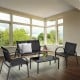 4-piece black patio furniture set featuring a loveseat, two chairs, and a glass top coffee table for outdoor comfort.