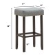 Gray nailhead saddle bar stool with solid rubberwood legs, 29-inch height, ideal for bars and kitchens.