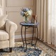 Round blue mosaic accent table with a floral clover design, featuring a robust metal frame for indoor or outdoor use.