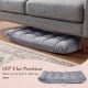 Light gray cushioned floor chair in flat position, featuring thick padding and adjustable design for easy storage.