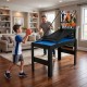 Child playing basketball on the 14-in-1 combo game table set, perfect for family gatherings and game rooms.
