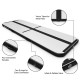 Inflatable gymnastics tumbling mat with D-rings, handles, and pump, made of durable waterproof PVC for versatile use.
