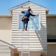 Worker using a 15 feet folding aluminum ladder to clean a window, showcasing its durable and safe design.