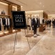 Black metal easel stand displaying a luxury apparel sale, ideal for events like weddings and art exhibits.