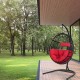 Hanging cushioned hammock chair with stand in red, featuring a sturdy frame and comfortable pillows for outdoor.