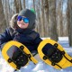 Kids snowshoes in yellow with adjustable bindings and trekking poles, perfect for winter outdoor adventures.