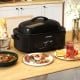 18QT electric roaster oven in black with self-basting lid, perfect for cooking a whole turkey and large meals.