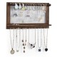 Wall mounted jewelry rack made of pine wood with metal hooks, featuring organized storage for necklaces, earrings, and.