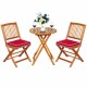 Folding wooden bistro set with red cushioned chairs and round table, perfect for outdoor dining and relaxation.