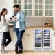 Dual-zone 24-inch wine and beverage cooler with clear glass doors, holding 18 wine bottles and 57 cans, ideal for home.