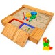 Cedar sandbox with detachable seats, two storage boxes, and toys for kids to dig and explore in the backyard.