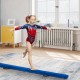Child practicing on a blue 7-foot folding balance beam with handles, designed for gymnasts to enhance balance and.