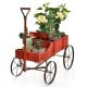 Wooden wagon plant bed in red with two planting sections and metal wheels, perfect for garden or patio decoration.
