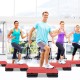 Adjustable red aerobic stepper platform with risers for varied workout intensity, ideal for home and gym exercises.