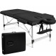 Portable black massage bed with adjustable height, includes headrest and armrests, ideal for spa and facial treatments.